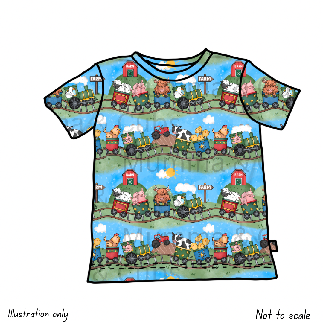 Children's t-shirt with farm-themed design featuring animals and tractors on a blue background.
