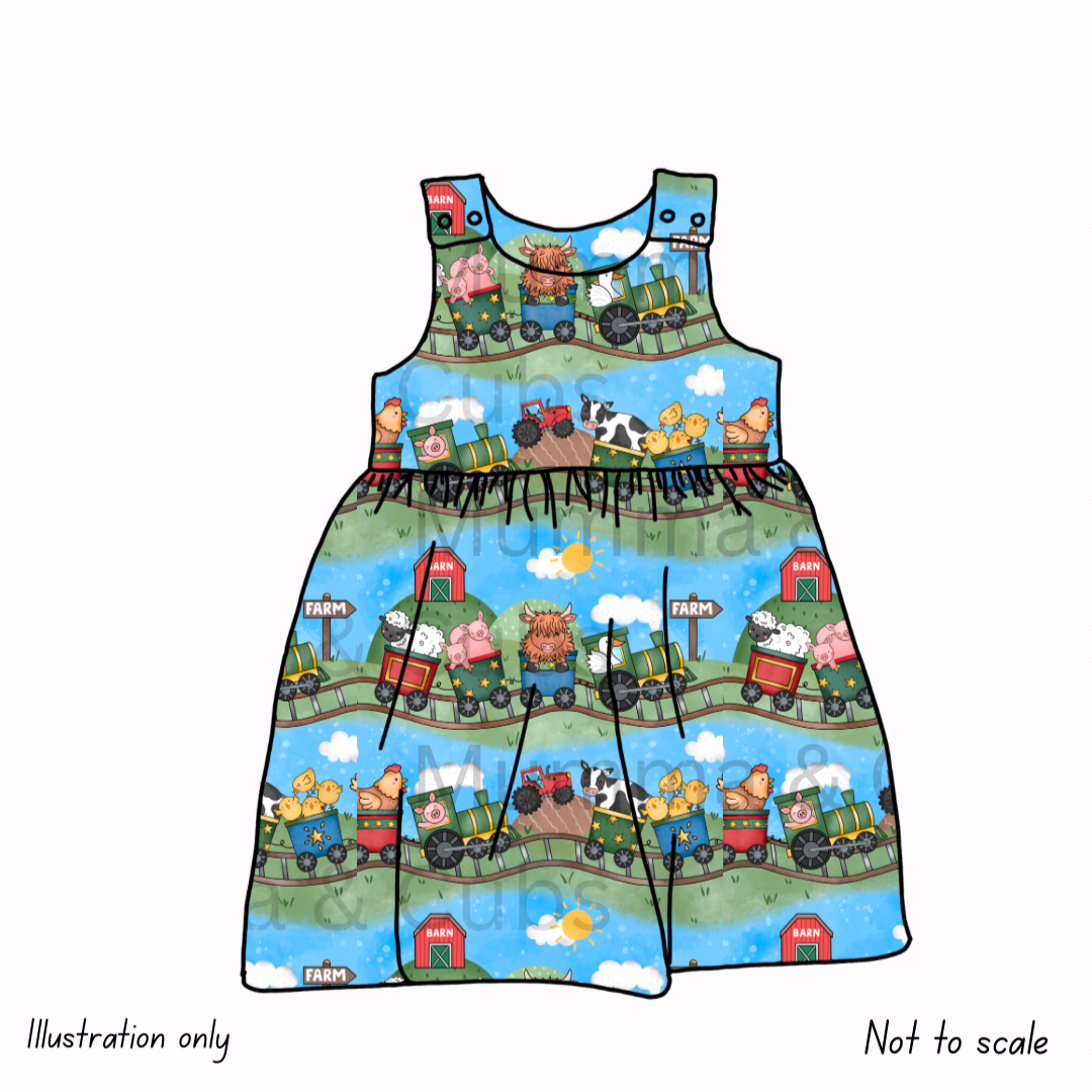Children's dress with farm-themed design on a white background