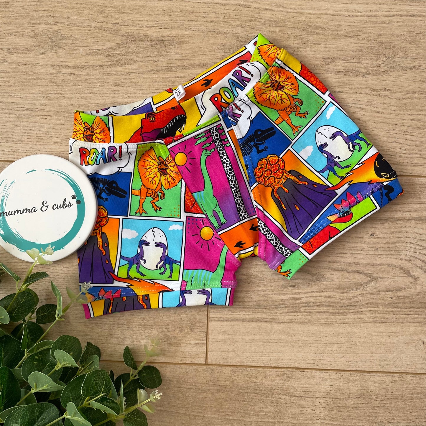 Colorful fabric with cartoon designs on a wooden surface