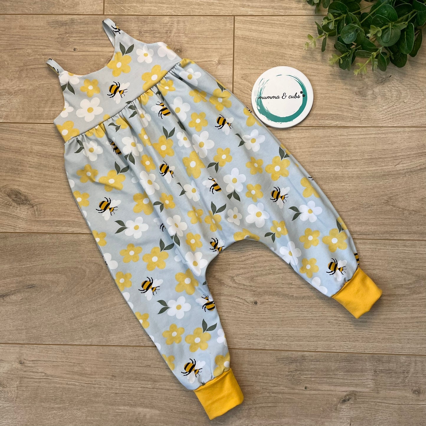 Childs romper with flowers and bees on with yellow cuffs